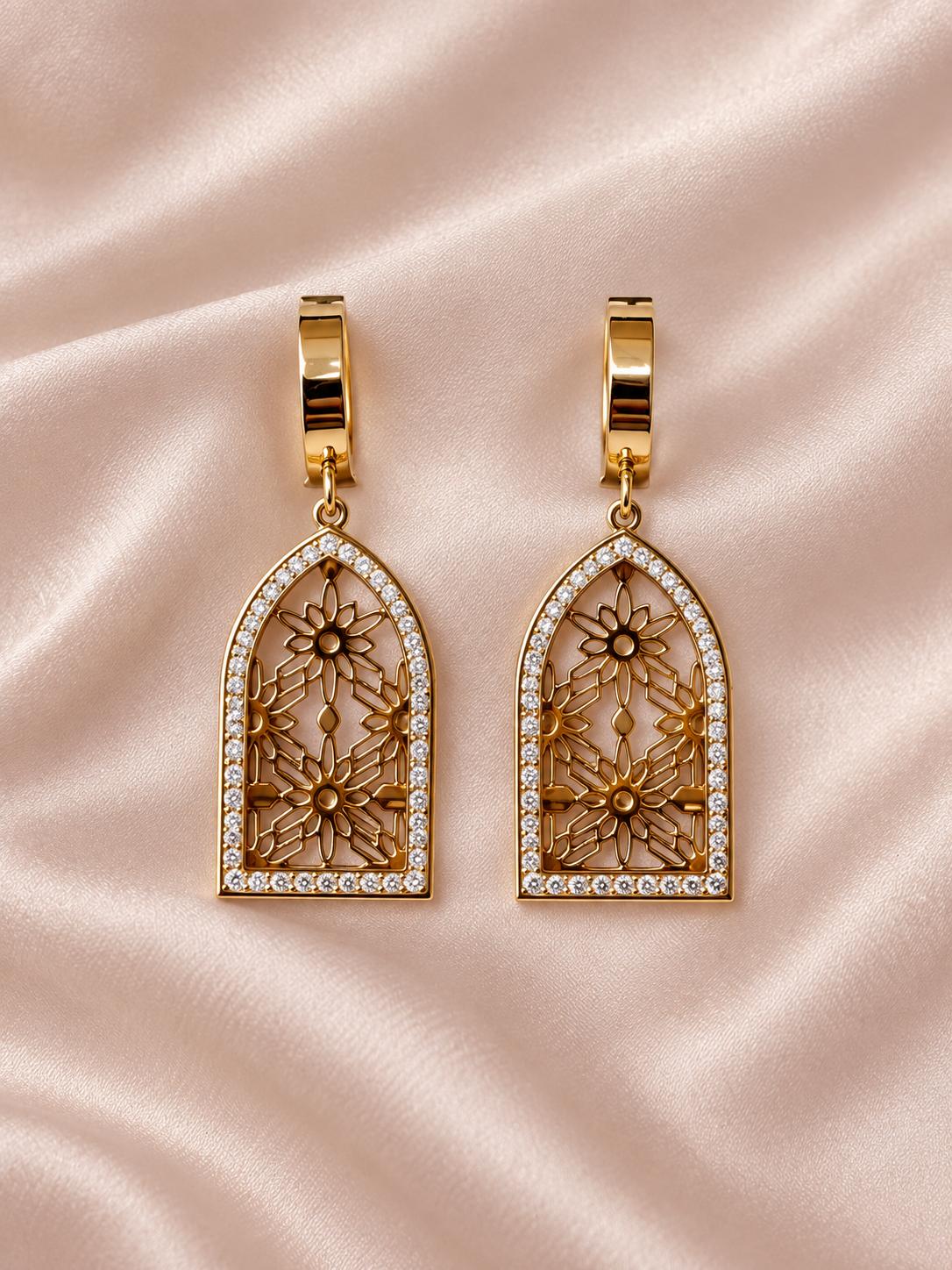 Aretes largos dorados con diseño floral calado y detalles brillantes para mujer