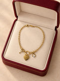 Pulsera Dorada con Dije de Corazón y Llave — Joyería Elegante y Romántica para Mujer